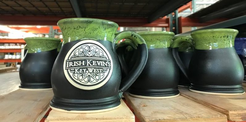 Black and green brewery mug with logo medallion reading "irish kevin's" with a celtic scroll design.