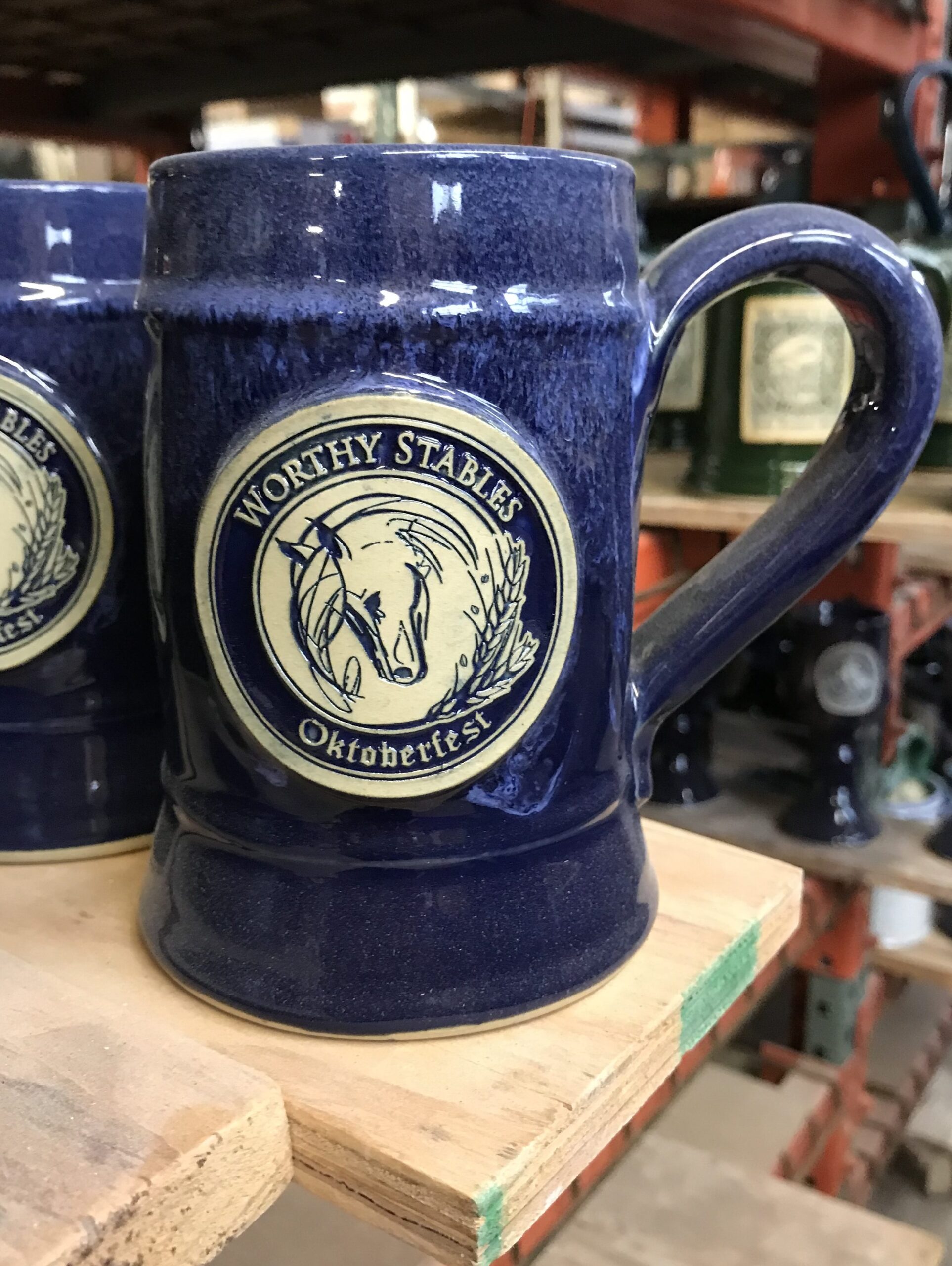 Blue handmade beer stein with custom logo.