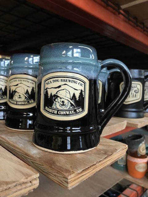 Black and blue beer stein with a drawing of a dog wearing a fisherman's hat and the text "Sea Dog Brewing Co, North Conway, NH".