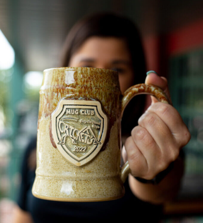 holding up a large ceramic beer stein