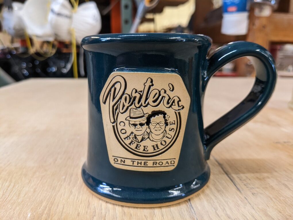Teal coffee mug with logo for Porter's Coffee shop.