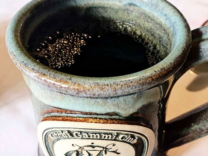 Mug filled with coffee.