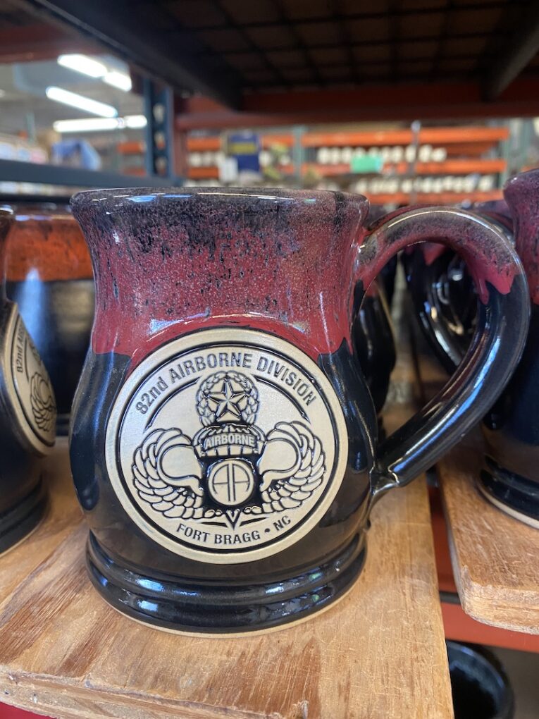Black and red handmade military mug with emblem.