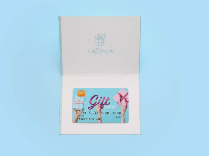 White note card with gift card inside.