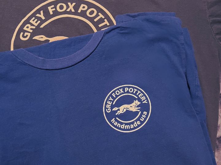 Blue tshirt with branded logo 'grey fox pottery handmade usa'