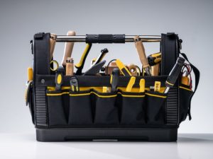 black tool caddy filled with a variety of tools for home improvement