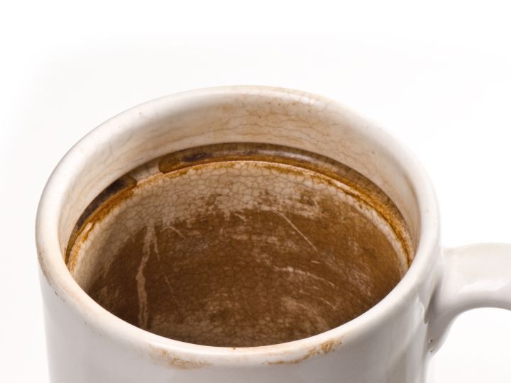 white coffee mug with brown stains on the inside
