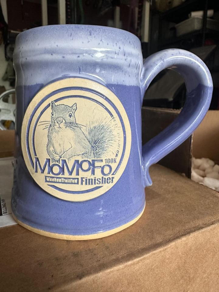 Purple coffee mug with clay medallion of a squirrel and text MoMoFo race