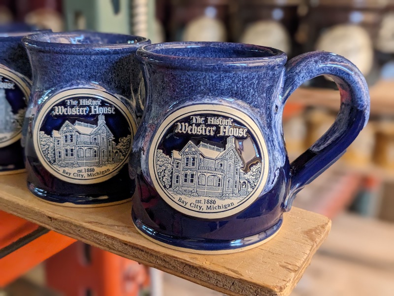 blue wholesale coffee mugs with a logo for a bed and breakfast