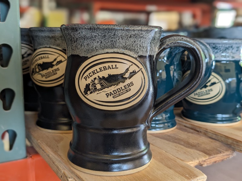 black beer mug with a sports team logo on it